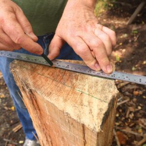 Drawing a line on the end grain of a bolt of wood