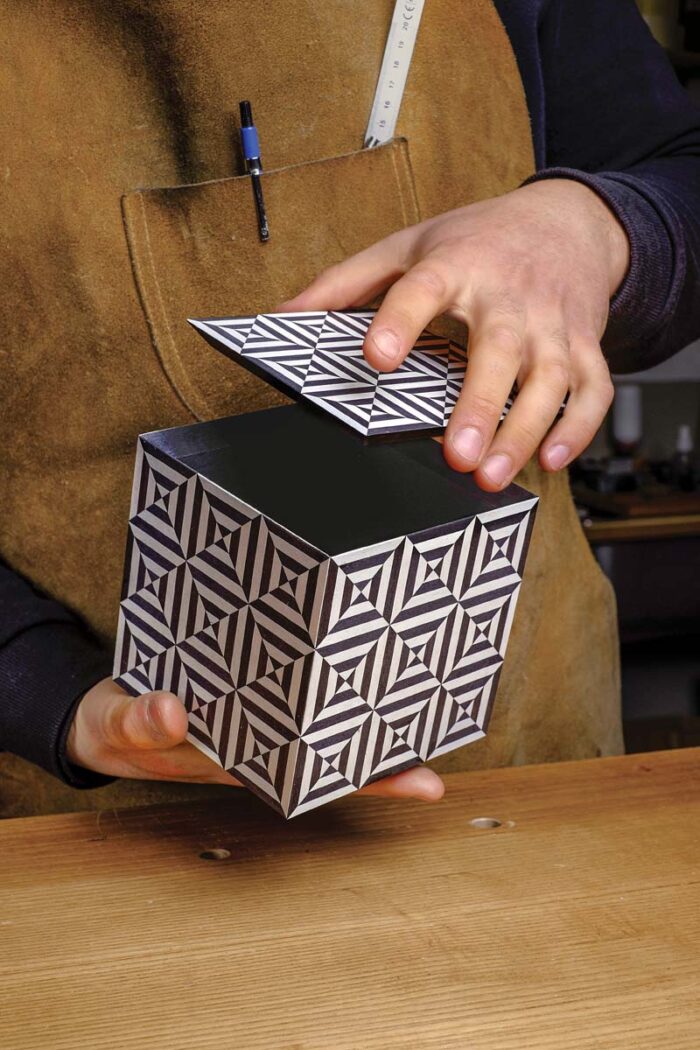 Vasko holds his completed box, with the lid lifted slightly. 