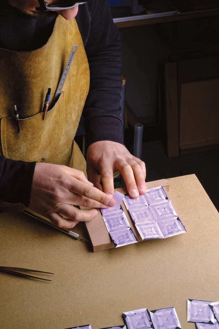 Vaskos uses purple tape to secure each square to another.