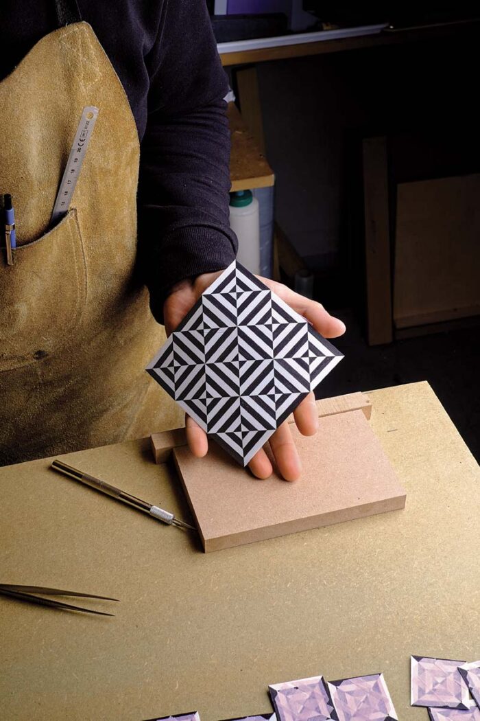 Vasko shows the final pattern he will apply to one of the sides.
